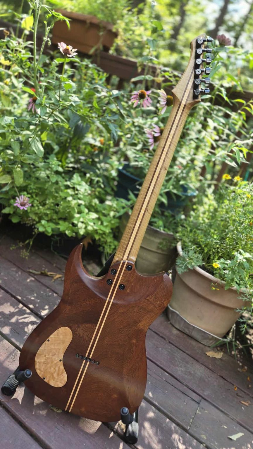 The back of a Severin STI specifically the roasted maple book matched with a sipo mahogany back and roasted maple neck.